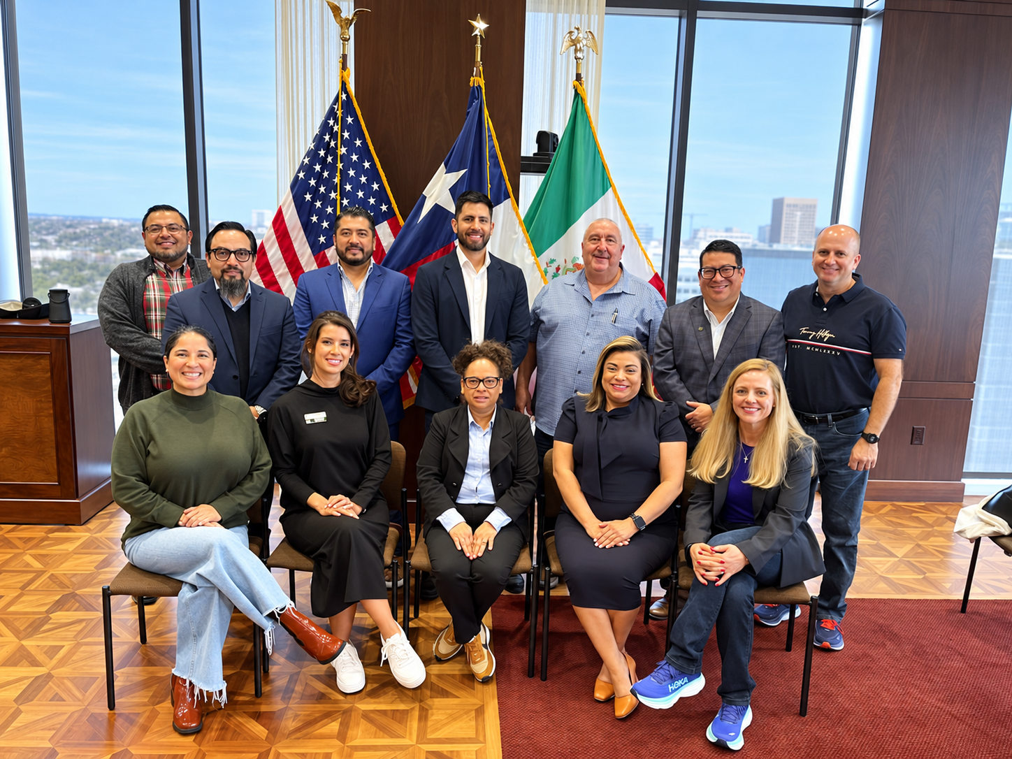 Leadership Tejas group portrait in front of the United States, Texas, and Mexico flags.