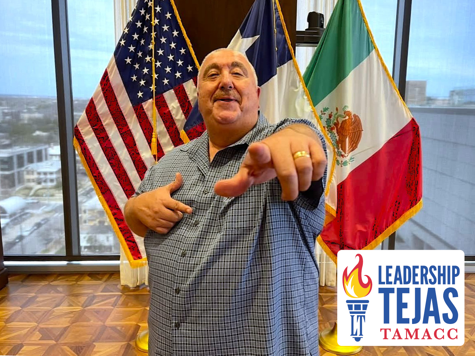 Leadership Tejas invitation to apply, with a man pointing toward the viewer in front of three flags.
